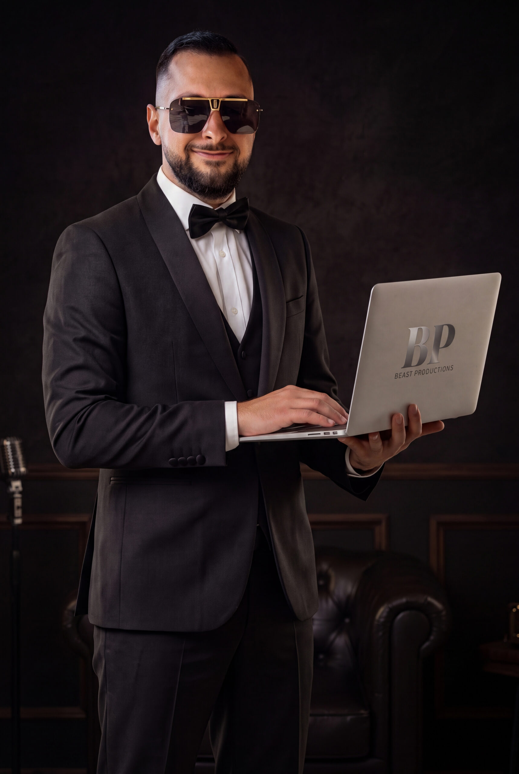 Omid Farahani holding a Beast Productions branded laptop